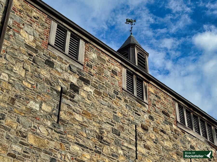 A stone building with a clock on it.